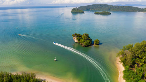 Aerial landscapes view sailing boat splashing water on the sea estuary pier phang nga province 