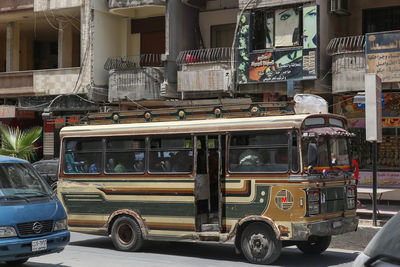 Vehicles on street by building