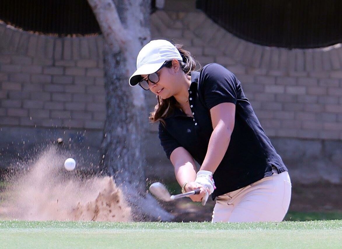 FULL LENGTH OF YOUNG WOMAN PLAYING WITH BALL