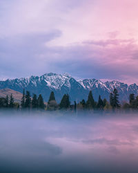 Scenic view of snowcapped mountains against sky during sunset