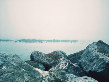 Close-up of person on shore against sky