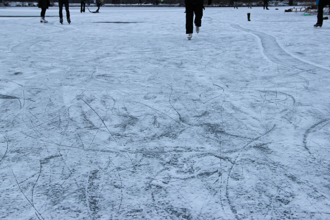 LOW SECTION OF PERSON STANDING ON SNOW