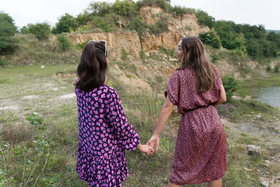 Rear view of women standing on field