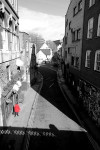 People on street in city against sky