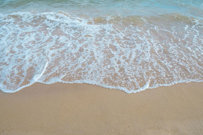 High angle view of waves rushing towards shore