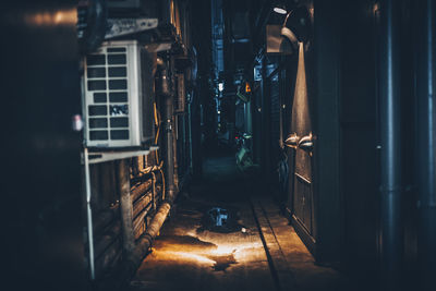 Alley amidst buildings at night