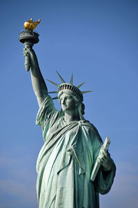 Low angle view of statue against blue sky