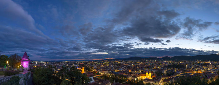 Illuminated cityscape against sky at night