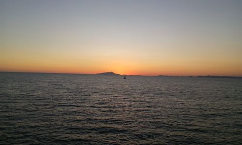 Scenic view of sea against clear sky during sunset