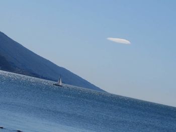 Scenic view of mountains against blue sky