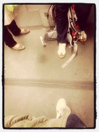 Low section of person standing on tiled floor