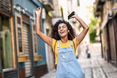 Portrait of smiling young woman standing outdoors