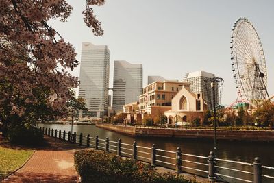 Bridge over river against buildings in city