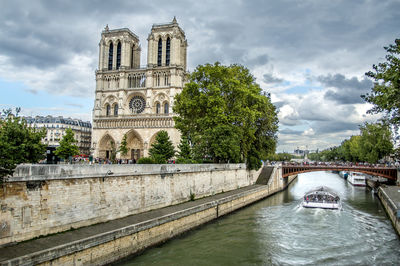 Bridge over river with notre dame de paris in city