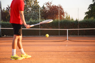 Low section of man playing tennis