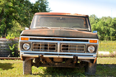 Abandoned car on field