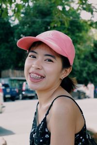 Portrait of smiling young woman wearing hat