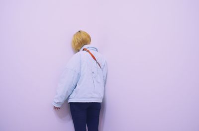 Woman standing against the wall