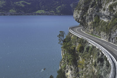 High angle view of road by sea against mountain