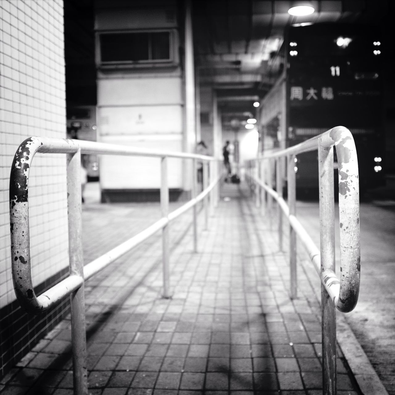 architecture, built structure, building exterior, empty, the way forward, railing, street, sidewalk, city, transportation, incidental people, absence, bicycle, walkway, footpath, outdoors, day, walking, sunlight, tiled floor