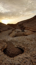 Scenic view of desert against sky during sunset