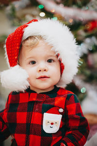 Portrait of cute baby boy wearing santa hat