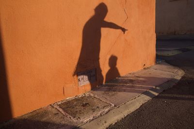Shadow of man on street