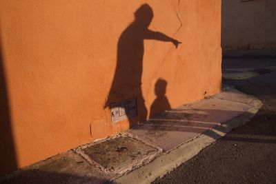 Shadow of woman and child on street
