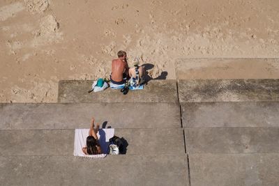 People sitting on wall