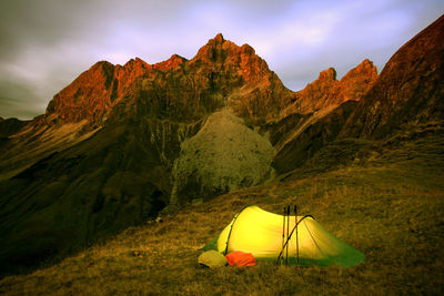 Scenic view of tent and mountains against sky