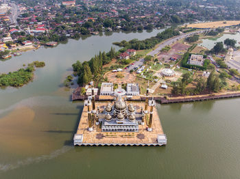 High angle view of crystal mosque by river 