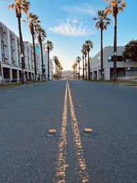 Road amidst buildings against sky