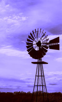 Low angle view of ferris wheel against sky