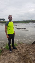 Full length of young man standing on beach