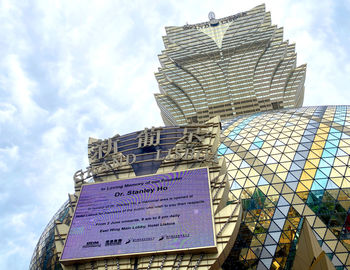 Low angle view of text on building against sky