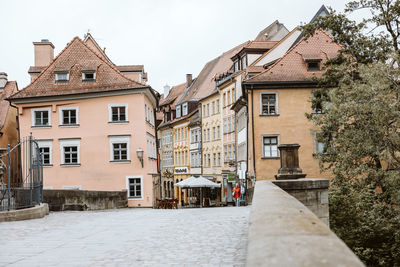 Houses by street in town against clear sky