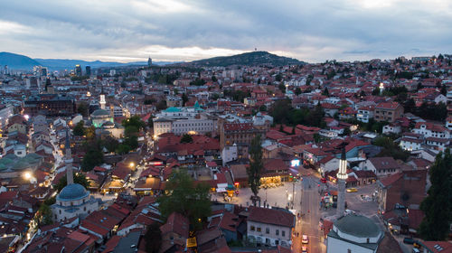 High angle shot of illuminated cityscape against sky