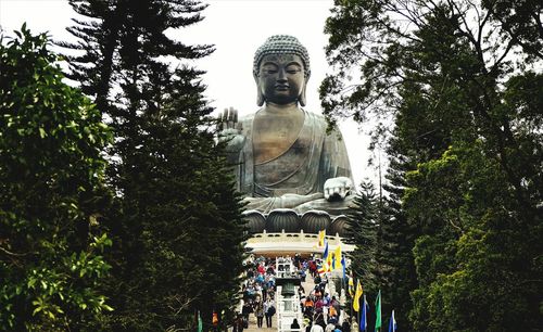 Low angle view of statue against trees