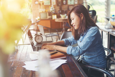 Woman sitting on table at cafe