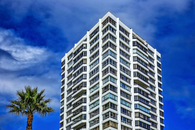 Low angle view of modern building against blue sky