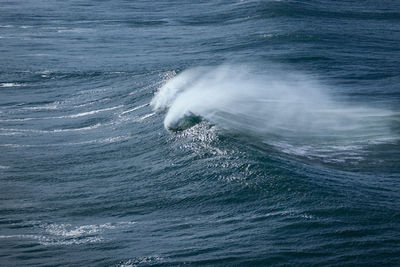 High angle view of waves splashing in sea