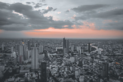 Aerial view of modern buildings against sky during sunset