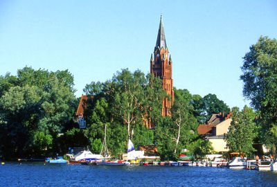 Boats in river with buildings in background