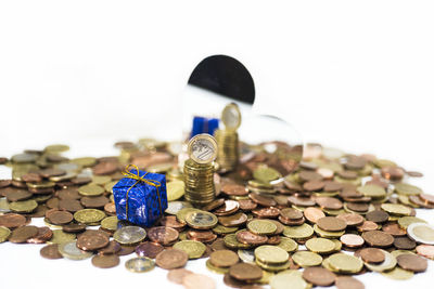 Close-up of coins on metal against white background