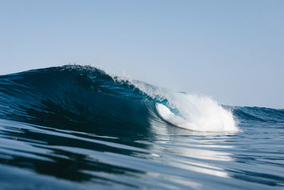 Blue wave breaking on the beach in tenerife