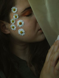 Midsection of woman with pink flower in sunlight