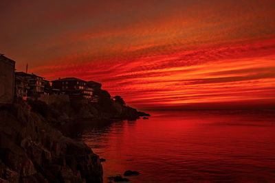 Scenic view of sea against orange sky