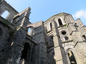 Low angle view of old abbey building against sky