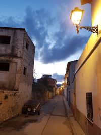 Street amidst buildings against sky in city