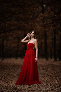 Young woman standing in a forest